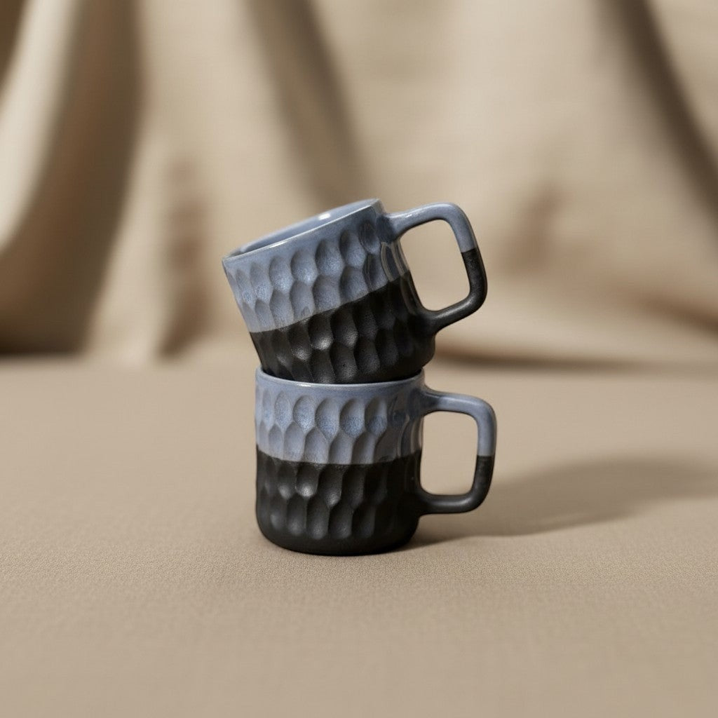 Eternal Pottery two-tone blue and charcoal ceramic coffee mug with geometric texture and comfortable handle.