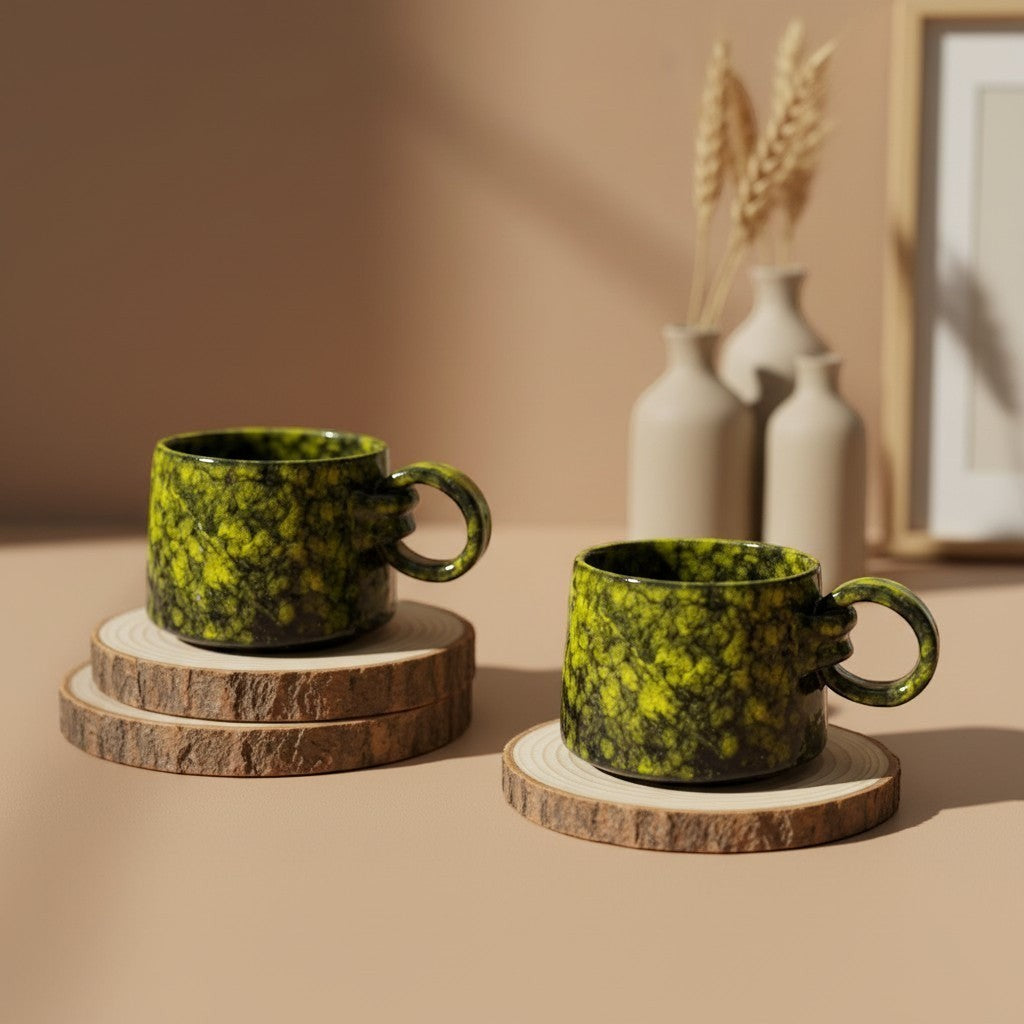 Two textured forest glow ring mugs with handles resting on wooden coasters, rustic design. Eternal Pottery.